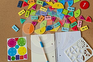 back to school background. colorful math fractions and notebook on the table. Mathematics