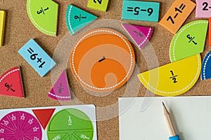back to school background. colorful math fractions and notebook on the table. Mathematics