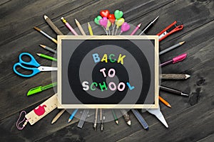 Back to school background concept. Back to Scool wood text arrange on blackboard on wood background with School supplies, station photo