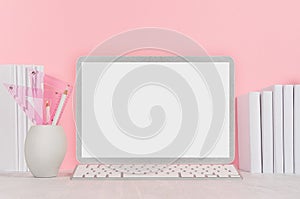 Back to school background for girl`s - white stationery, blank laptop computer and books on soft pink wall and white wood desk.