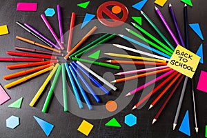 Back to school background with a lot of colorful felt-tip pens and colorful pencils in circles and title `Back to school`