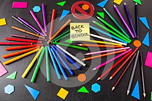 Back to school background with a lot of colorful felt-tip pens and colorful pencils in circles and title `Back to school`