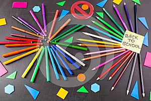 Back to school background with a lot of colorful felt-tip pens and colorful pencils and title Back to school written