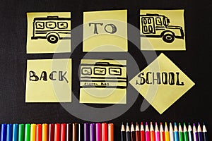 Back to school background with a lot of colorful felt-tip pens and colorful pencils, titles `Back to school`