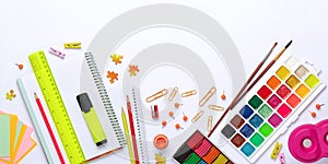 Back to school background. Plasticine for crafts, pencils, notebooks, ruler and aquarelle paints. Colorful stationery on table,