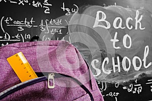 Back to school background with purple school bag with yellow ruler and the title `Back to school` and math formulas