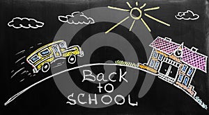 Back to school background with school bus and school are written by colorful chalks on the black school chalkboard