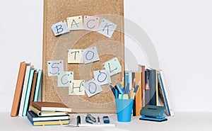 Back to school background. Stationery accessories â€“ notebooks piles, plastic holder pencils, pens, markers, stickers, notepads,