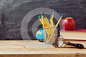 Back to school background with teachers objects over chalkboard photo