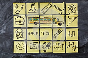 Back to school background with title Back to school, school bus and school attributes written on the pieces of paper
