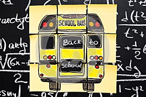 Back to school background with title `Back to school` and `school bus` written on the yellow pieces of paper on the chalkboard photo