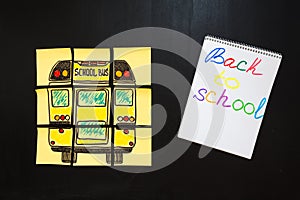 Back to school background with title `Back to school` and `school bus` written on the yellow pieces of paper photo