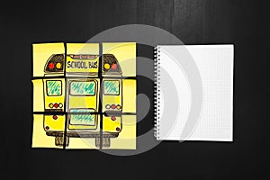 Back to school background with title `Back to school` and `school bus` written on the yellow pieces of paper and notebook