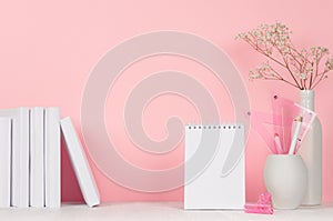 Back to school backgrounds for girl - white and pink stationery, books, blank notepad on white wood table and pink wall.