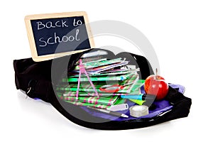 Back to school: blackboard slate on bag with books