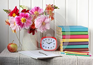 Back to school. bouquet of dahlias and textbooks