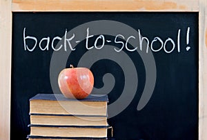 Back to school on chalkboard with apple & books