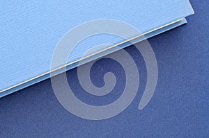 Back to school,close up on blue book covers, minimal background