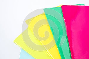 Back to school, colored copybooks in a white background