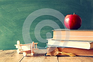 Back to school concept. Blackboard with books and apple