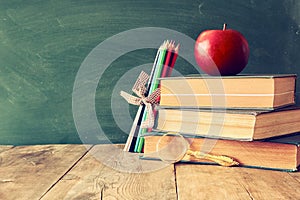 Back to school concept. Blackboard with books and apple