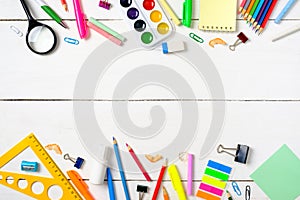 Back to school concept, border frame of colorful stationery supplies for teaching kids drawing on empty white wooden desk.