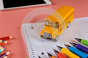 Back to school concept with bus and notebook pencil