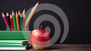 Back to school concept. Close-up photo of colorful crayons red apple and