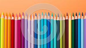 Back to school concept, colored pencils on orange background, copy space, top view, flat lay, teacher's day