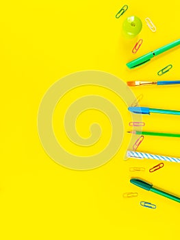 Back to school concept. Colorful office stationery on yellow background