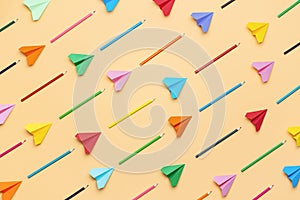 Back to school concept. Colorful pencils and paper airplanes pattern
