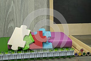 Back to school concept with colorful wooden puzzle