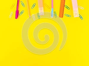Back to school concept. Colorful writing stationery on yellow background