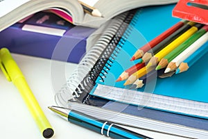 Back to School Concept. Composition from Supplies Stack of Copybooks Multicolored Pencils Highlighter Rubber Pen Opened Workbook