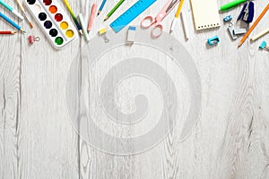 Back to school concept, creative layout with with various school supplies and stationery on wooden desk table. Flat lay design,