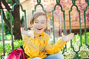 Back to school concept. Cute boy outside at school having good time