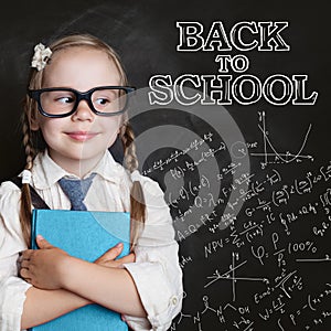 Back to school concept. Cute little girl in glasses