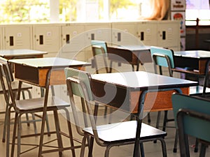 Back to school concept.Empty elementary class room  with chairs ,tables and student lockers