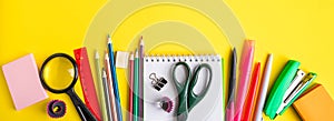 Back to school concept. Flat lay of office supplies on yellow background. Place for text