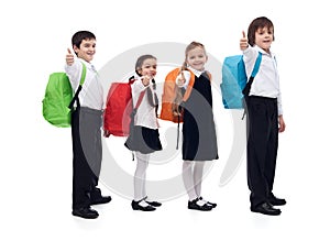 Back to school concept with happy kids giving thumbs up sign