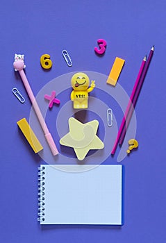 Back to school concept. School and office supplies on the office table. Violet background.Flat lay