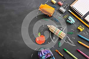 Back to school concept. rocket, bus and pencils over classroom blackboard. Top view