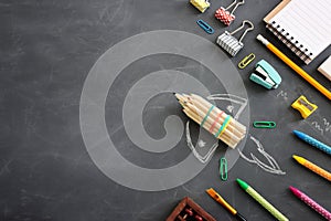 Back to school concept. rocket and pencils over classroom blackboard. Top view