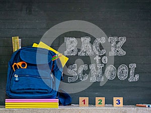 Back to school concept. School bag with stationery and notebooks