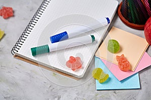 Back to School concept, school supplies, biscuits, packed lunch and lunchbox over white chalkboard, selective focus.