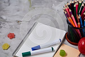 Back to School concept, school supplies, biscuits, packed lunch and lunchbox over white chalkboard, selective focus.