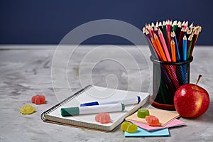 Back to School concept, school supplies, biscuits, packed lunch and lunchbox over white chalkboard, selective focus.