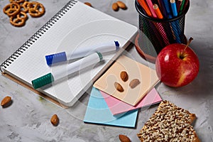 Back to School concept, school supplies, biscuits, packed lunch and lunchbox over white chalkboard, selective focus.