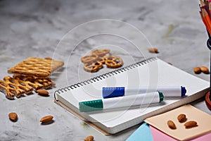 Back to School concept, school supplies, biscuits, packed lunch and lunchbox over white chalkboard, selective focus.