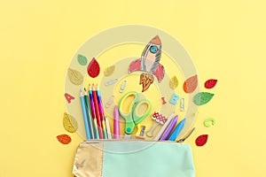 Back to school concept. Top view image of student stationery over pastel yellow background